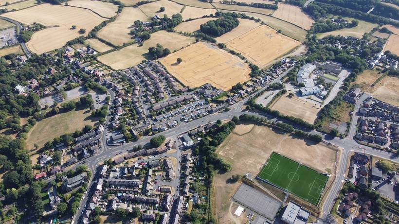 Aerial view over the rooftops of Kingstone with farmland beyond.